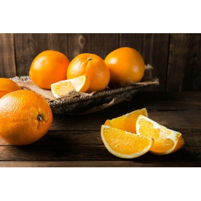 Fresh ripe oranges and slices of oranges